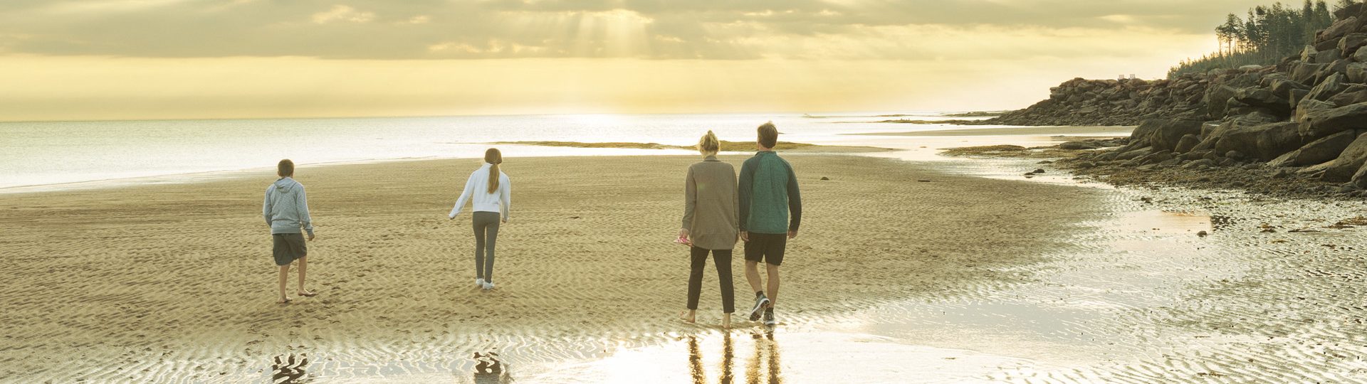 Family on the beach at Fox Harb'r Resort